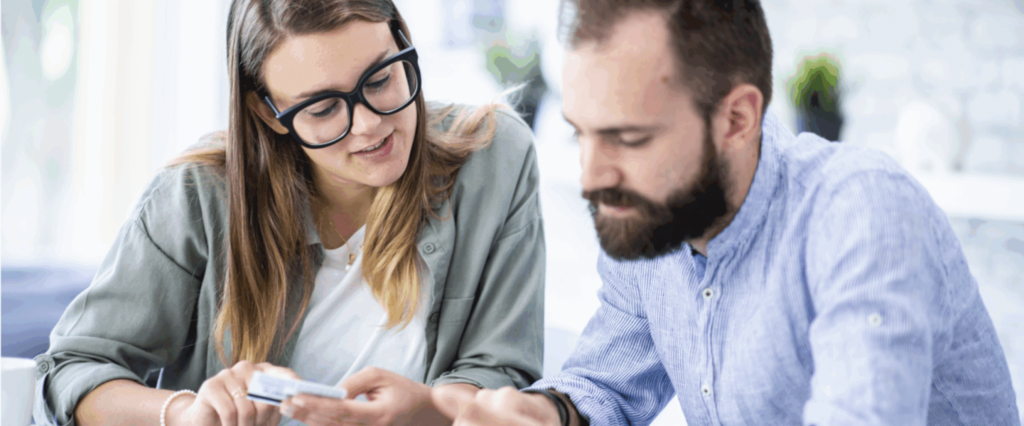A man chatting with his financial advisor to find out what a 677 credit score means.