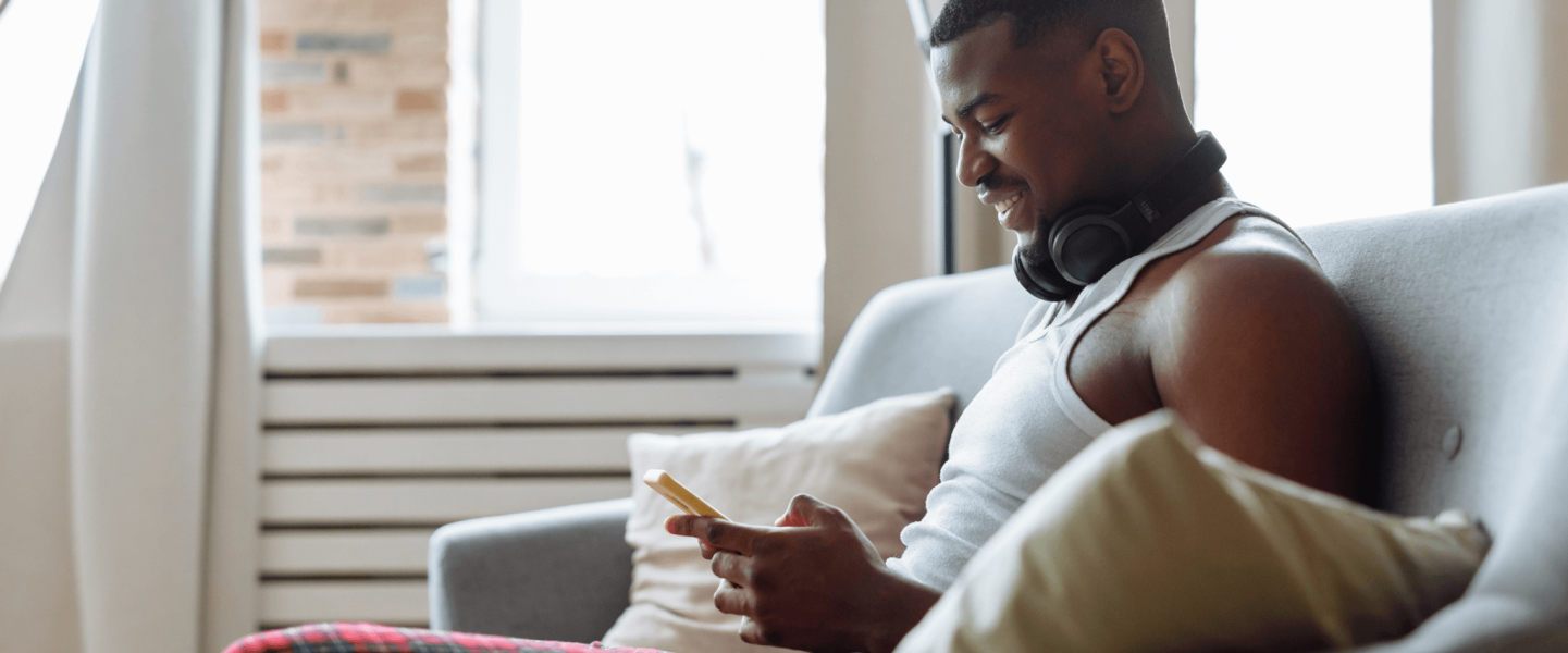 A man on his phone researching his 644 credit score.