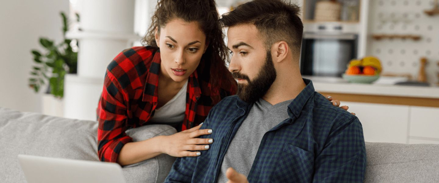 A couple reviewing their bad credit to see how they can get a new AC unit.