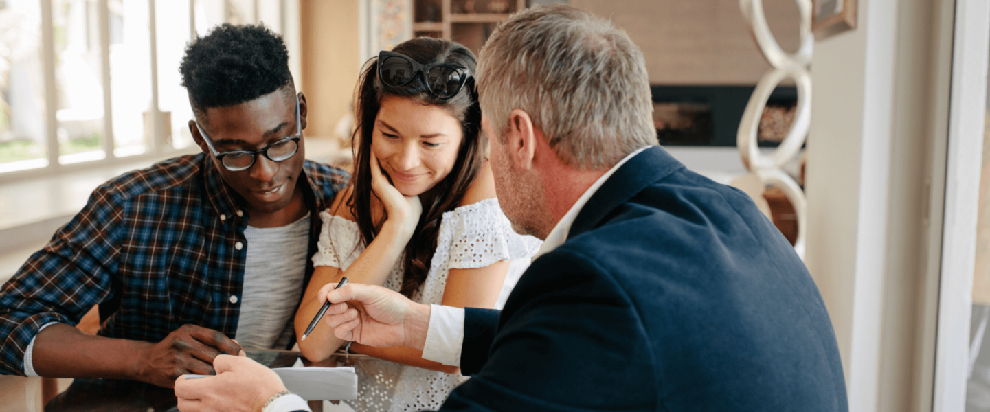 A couple talking to a realtor.