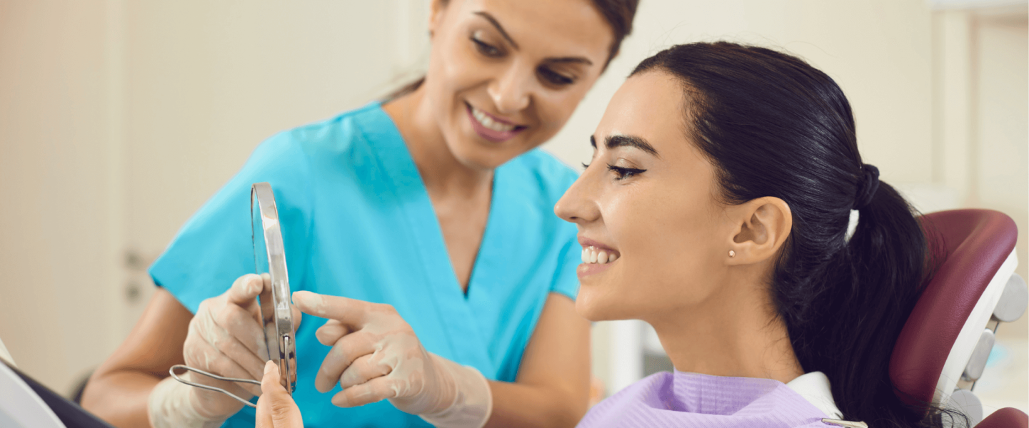 A woman getting dental implants with bad credit.