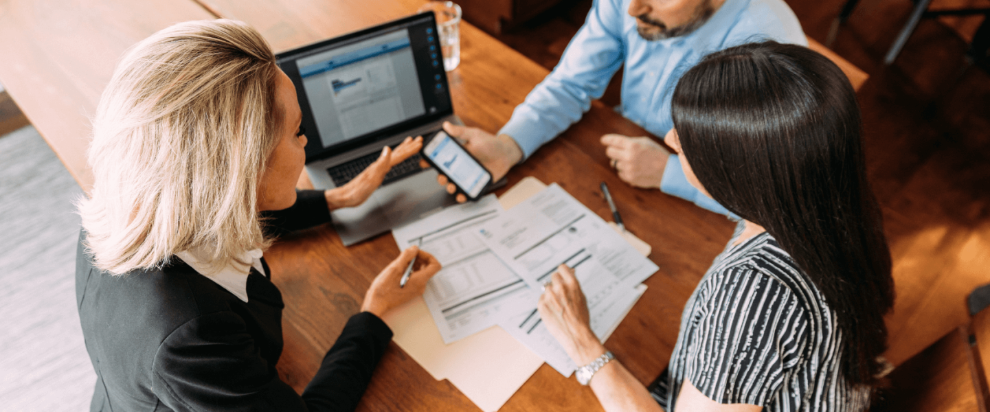 A couple talking to a financial agent to plan for the new year.
