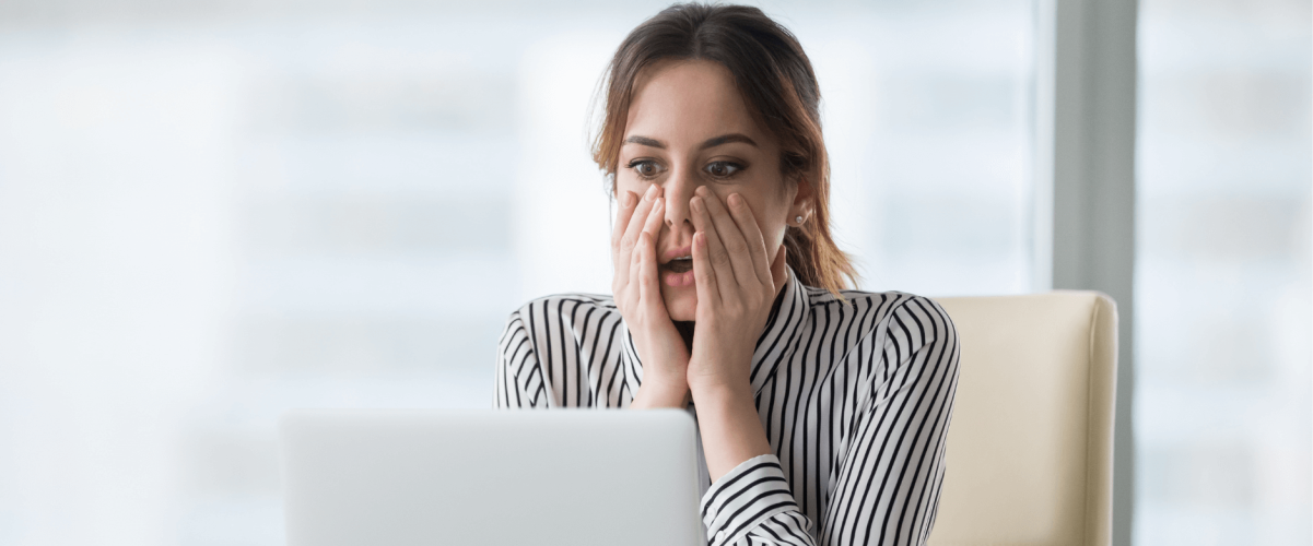 A woman realizing she is late making her student loan payment
