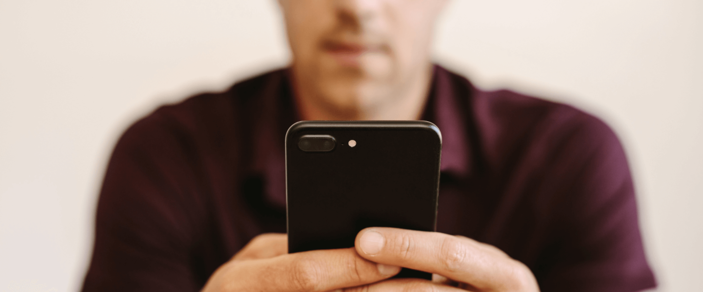 Man using his phone to check his credit score.