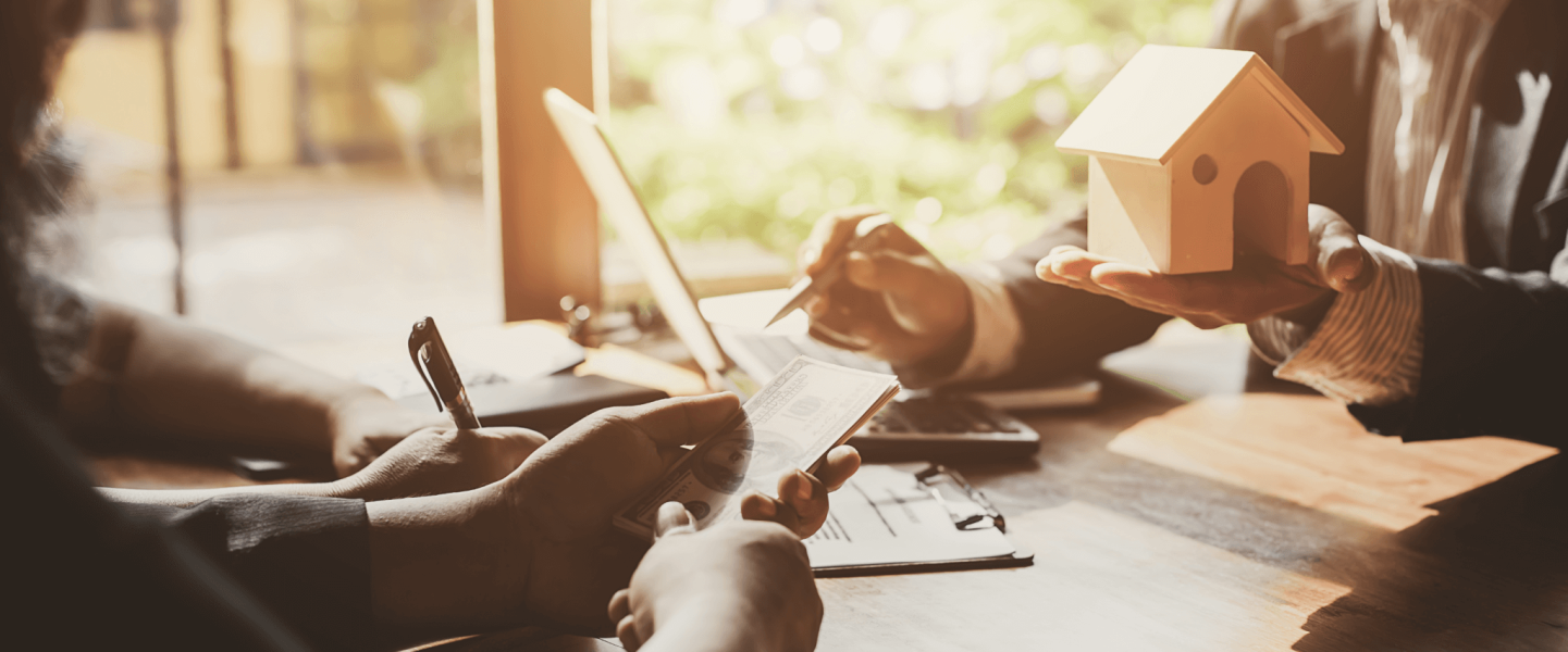 A couple talking to an agent about selling their house.