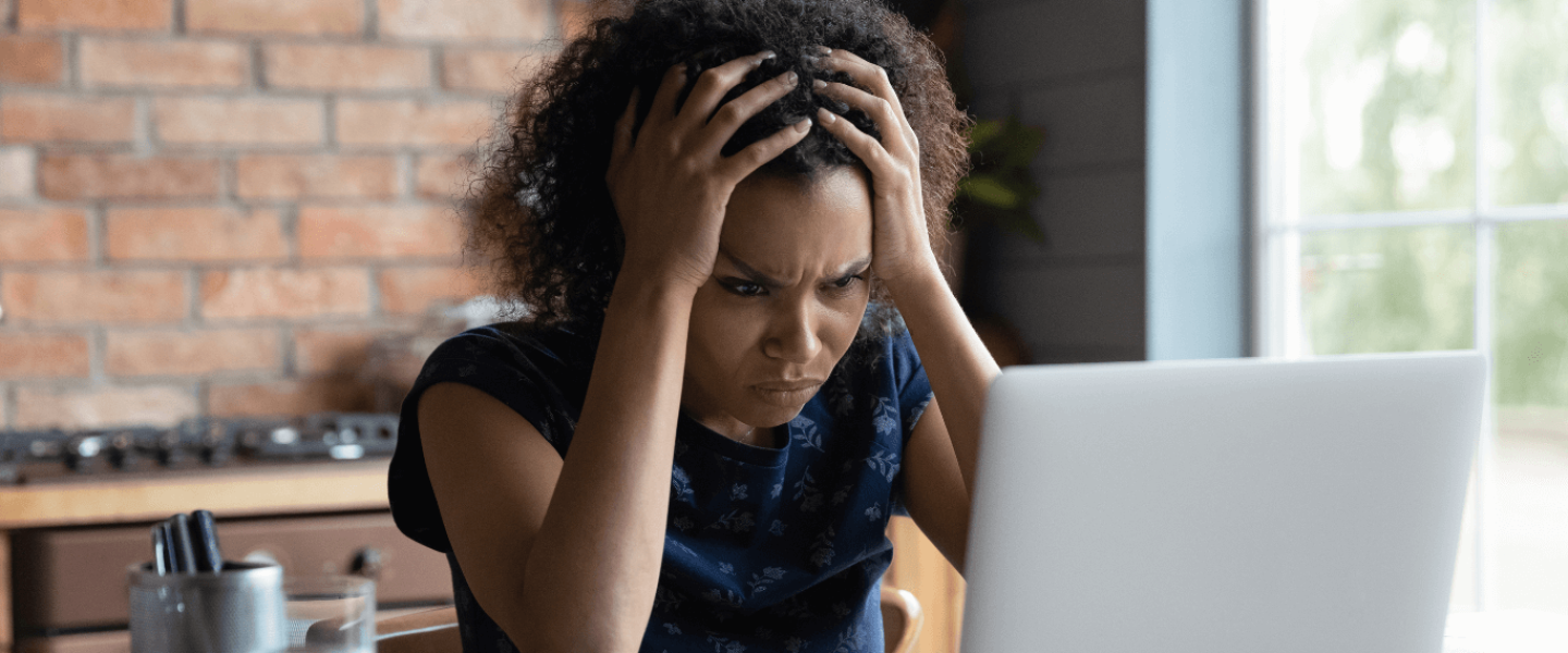A confused woman trying to figure out how to fix a mixed credit file.