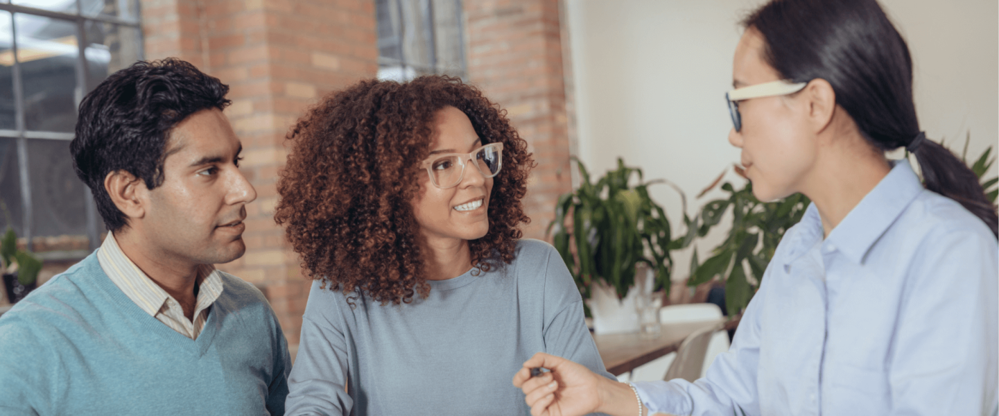 A couple talking to a financial advisor.