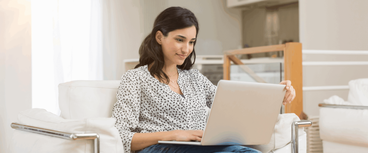 A woman researching how to remove a closed account from on her credit report.