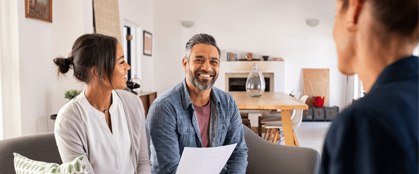 A couple speaking with an advisor.