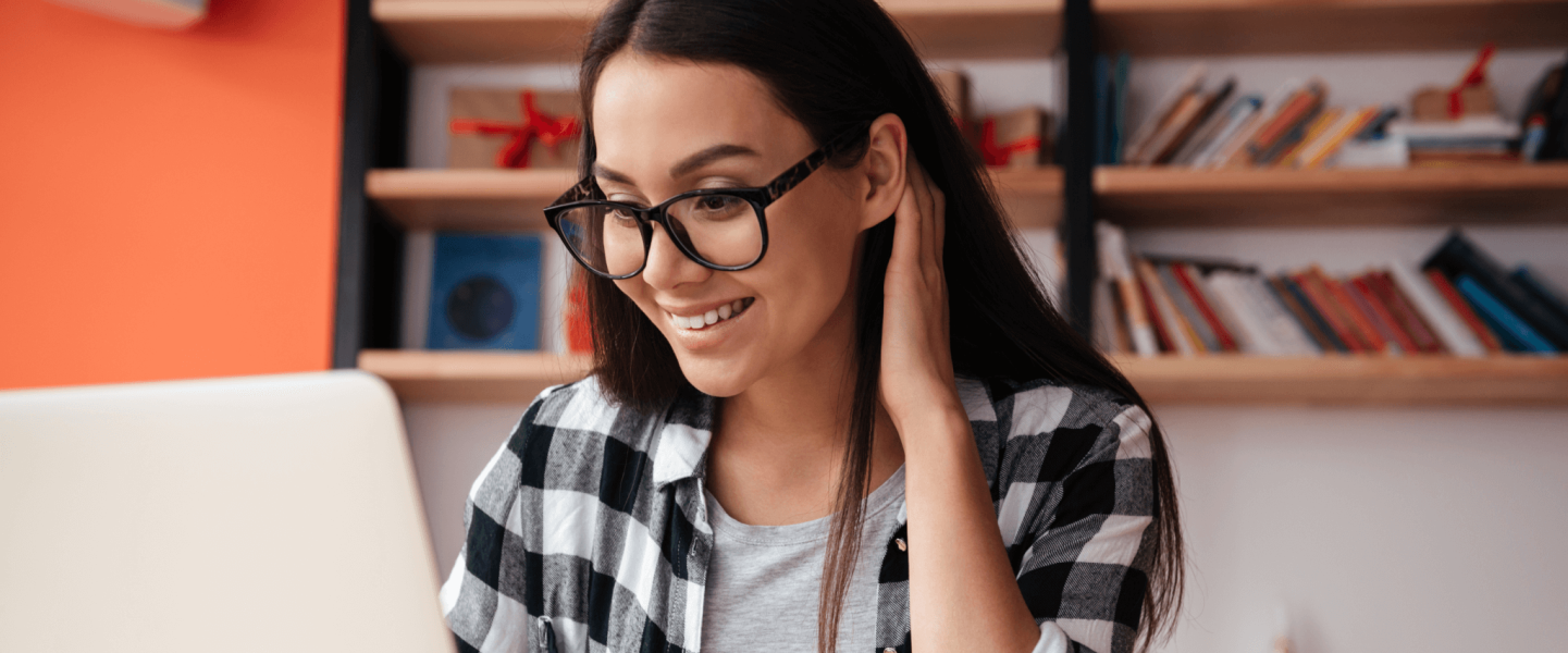 Woman wearing glasses and using her laptop.