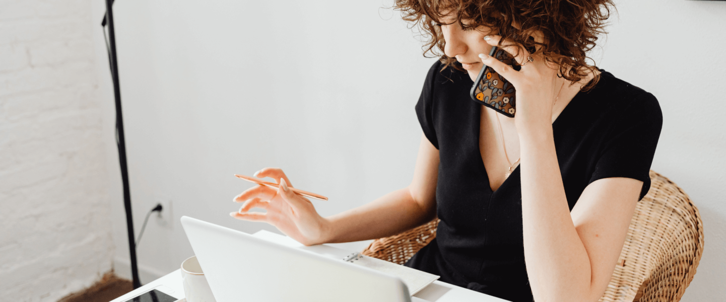 Woman on the phone looking into her finances.