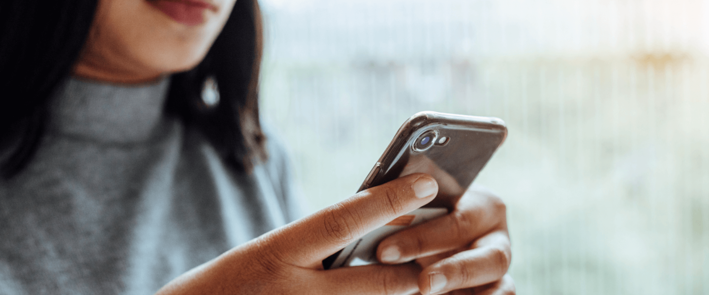 A woman researching about payday loans on her phone.