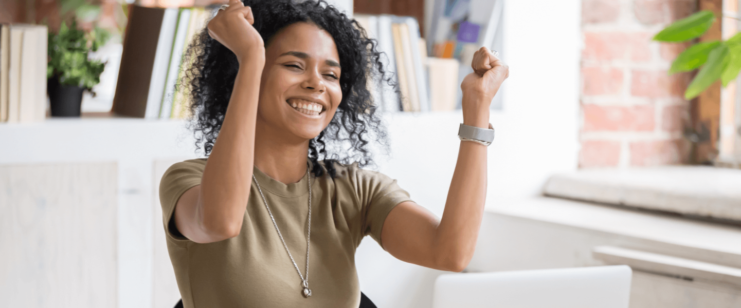 A woman celebrating her 806 credit score.