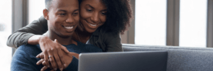 A couple looking at a laptop together
