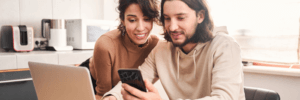 A couple checking their credit scores and finances to prepare for renting a home.